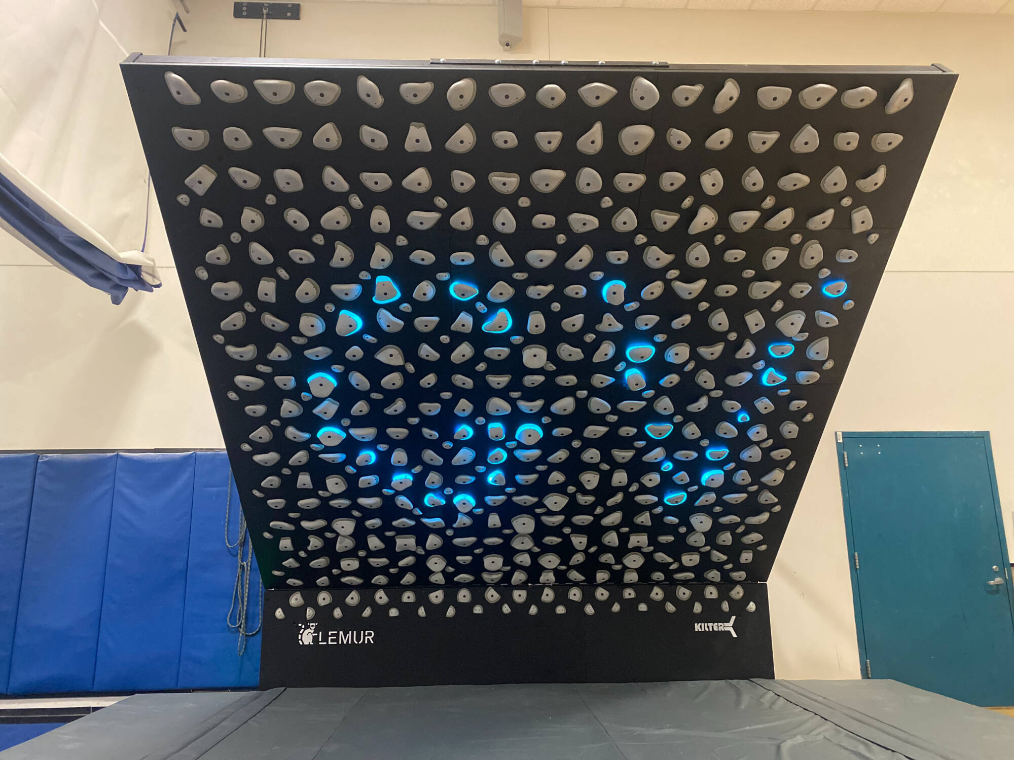 Kilter board with "GV" spelled with the light up rocks
